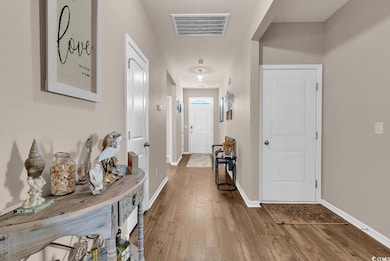 Hall with wood finished floors and baseboards