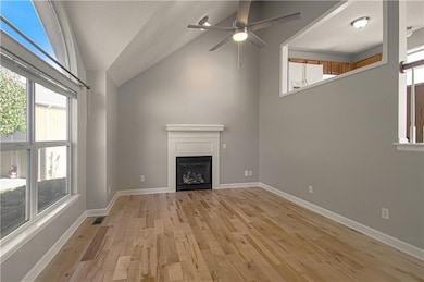 WOW! The light-filled great room welcomes you with gleaming refinished wood floors and a cozy gas fireplace — the perfect spot for relaxing or entertaining on cool Kansas evenings.  Enjoy the freshly interior paint throughout!!  Ready to move in!