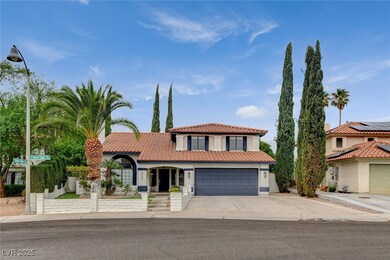 Mediterranean / spanish house featuring stucco siding, concrete driveway, a tiled roof, and a garage