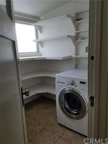 Laundry room with washer/dryer combo machine.