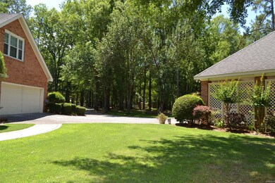 There's ample parking with a circular driveway, an attached double garage plus a detached double carport.