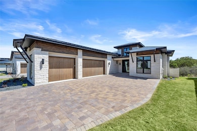 Contemporary home with metal roof, stone siding, 