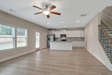 Kitchen featuring an island with sink, stainless s