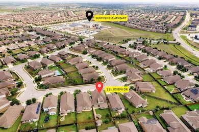 Aerial view of property and surrounding area with