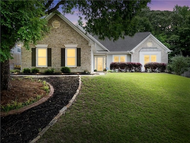 View of front of property with brick siding and a yard
