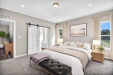 Bedroom featuring a barn door, connected bathroom, carpet flooring, recessed lighting, and ornamental molding