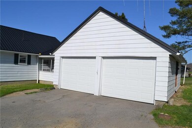 2 car detached garage with paved driveway