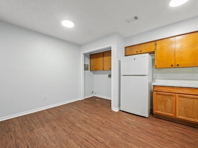 Kitchen with freestanding refrigerator, dark wood
