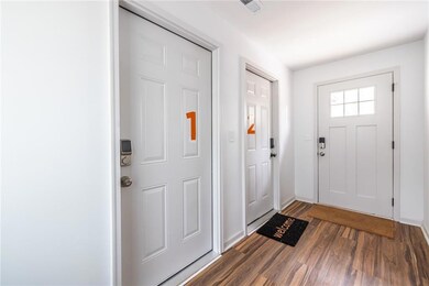 Entryway featuring visible vents and dark wood-sty
