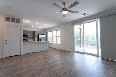 Unfurnished living room with dark wood-style floo