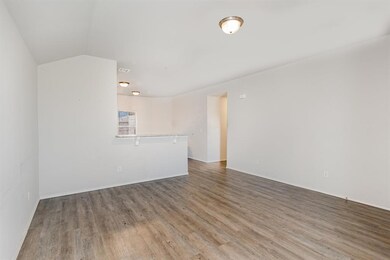 Living room towards kitchen and dining.