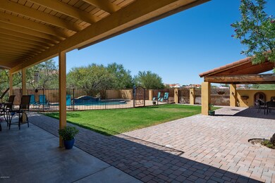 Backyard showing pool, ramada and grass