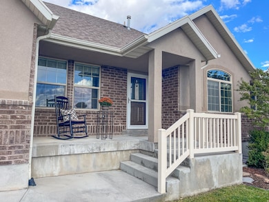 Entrance to property, brick siding, and stucco siding