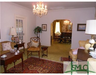 Living Room. Crown Moldings Glassed Door to Hallwa