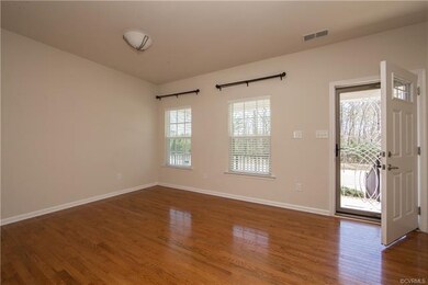 Open the door to a home that is welcoming with a  bright living room with gleaming hardwood flooring....