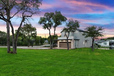 View of yard featuring an attached garage and dri