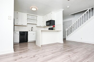 Kitchen with black appliances, open shelves, deco
