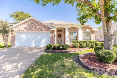 View of front of house with a front yard and a garage