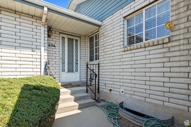 Entrance to property featuring brick siding
