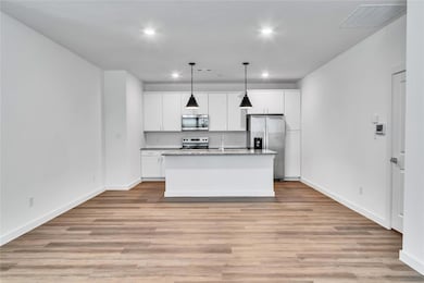 Kitchen with stainless steel appliances, white cab