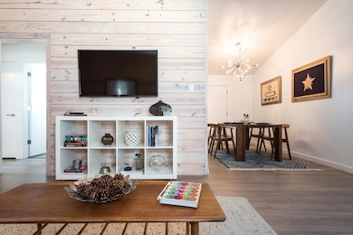 Living room featuring wood finished floors, a cha