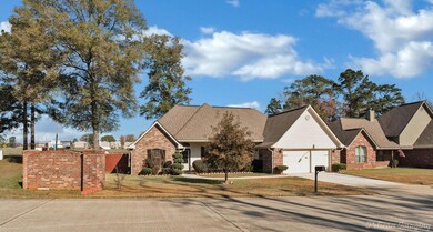 View of front of home with a front lawn and a gara