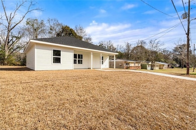 View of front of house with a porch and a front ya