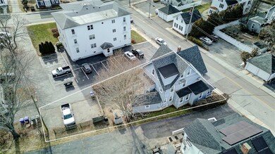 View of property and private parking behind house for three cars