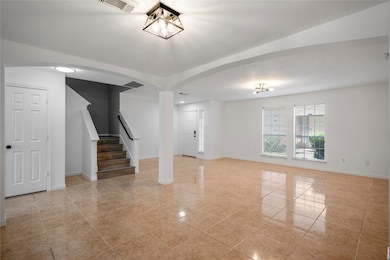 Reverse view of the foyer and living space with ample natural light.