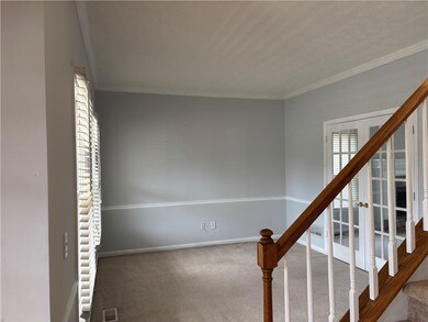 Living room with  french door and ornamental moldi