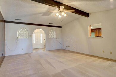 Carpeted empty room featuring ceiling fan, lofted 