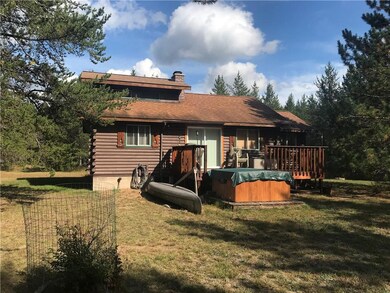 back of cabin with hot tub