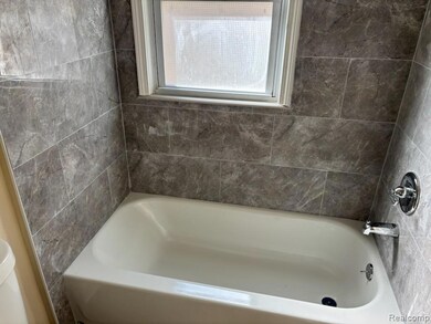 Full bathroom featuring a tub to relax in