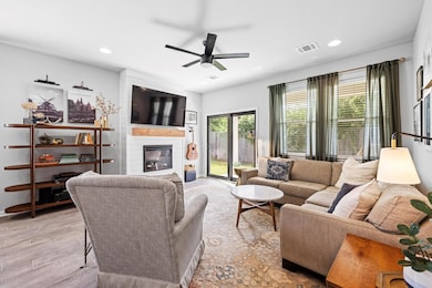 Living area with a large fireplace, plenty of nat