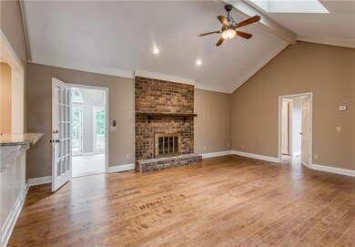 22x16 Den has hardwood floors, brick fireplace, new skylights, vaulted ceilings and it opens to sunroom and kitchen. 