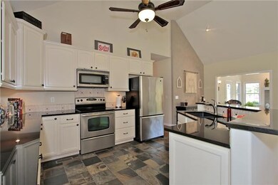 Slate Tile floors, custom glazed kitchen cabinets, stainless steel appliances, sleek granite tops.  What more can you ask for?