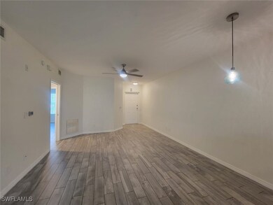 Spare room with wood finished floors and ceiling fan