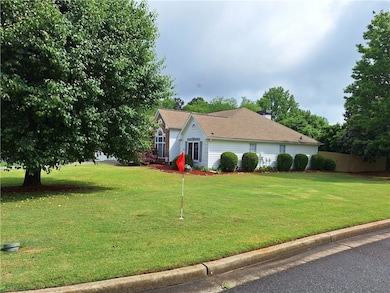 View of side of property with roof with shingles a