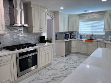 Kitchen with marble finish floor, appliances with