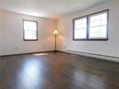 SPACIOUS LIVING ROOM WITH NEWER UPGRADE LAMINATE..