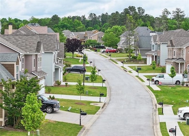 View of community with driveway, a residential vie