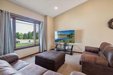 Bright living room with vaulted ceiling makes the main level.