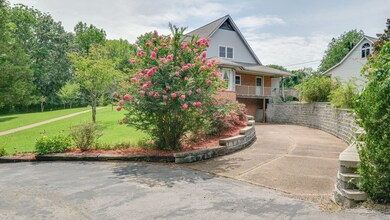 Garage entrance in basement of house. However, a three car detached garage is at the upper level. 