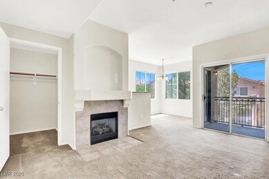 Unfurnished living room with a tiled fireplace, ba