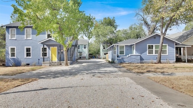 View of front of property with driveway and a shingled roof