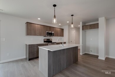 Kitchen featuring appliances with stainless steel finishes, modern cabinets, light wood-style flooring, recessed lighting, and light countertops