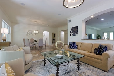 Living room featuring arched walkways, stone tile
