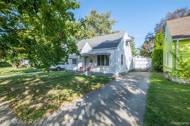 Bungalow-style house featuring a porch, roof with shingles, and an outbuilding