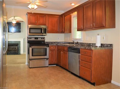 Kitchen leads to the family room with gas log fireplace. Neutral paint and beautiful floors!