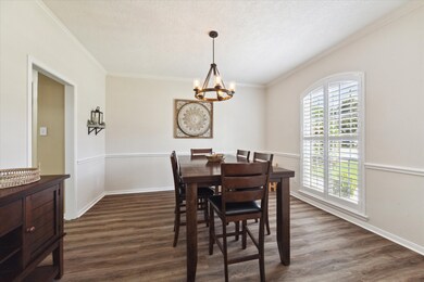The formal dining room is spacious, features plant